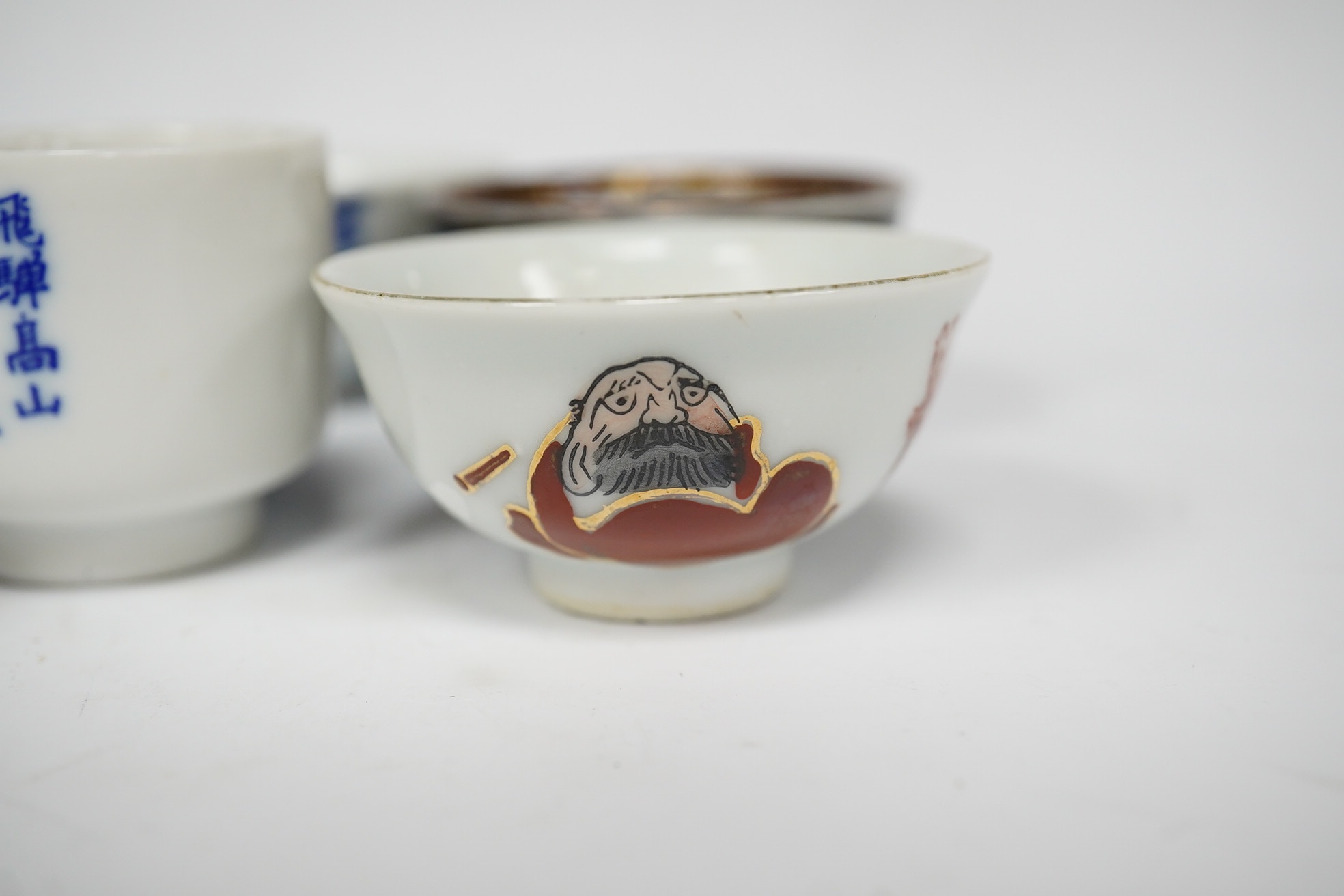 Six Japanese sake bowls, two pairs and two single, tallest 4cm. Condition - some chips